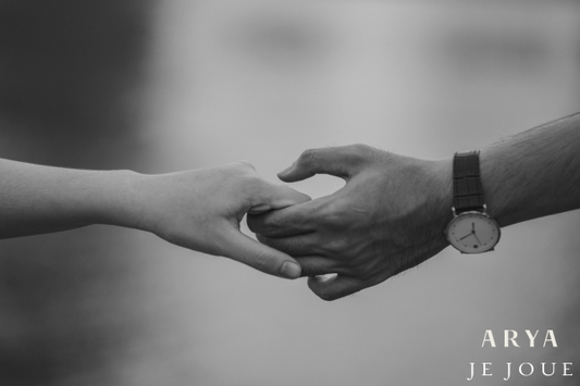 Two people holding hands black and white